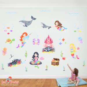Large mermaid wall sticker decal scene filled with rainbow coloured removable and reusable fabric wall stickers. a coral castle, 4 mermaids, a narwhal, whales and lots of fish, perfect for that bright colourful nursery or kids room decor.